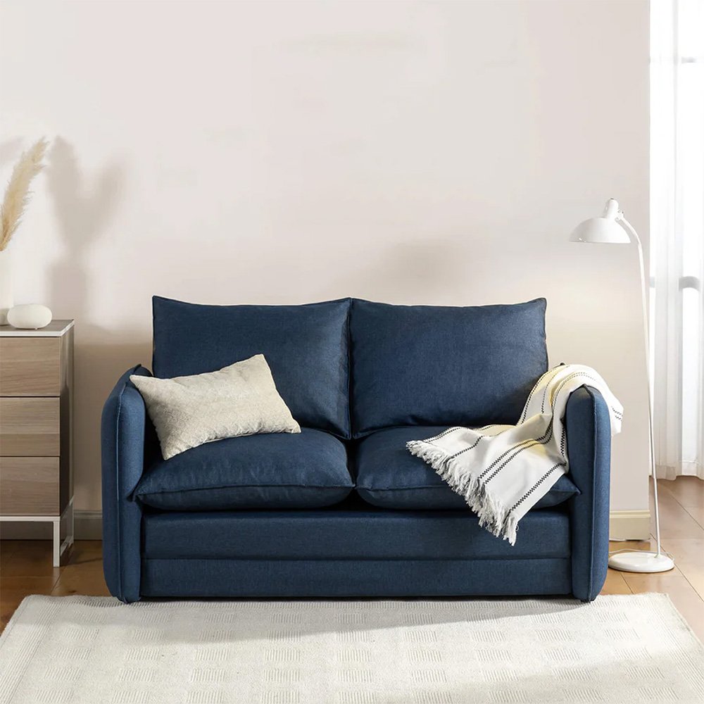 Navy sofa bed in a sunlit living room
